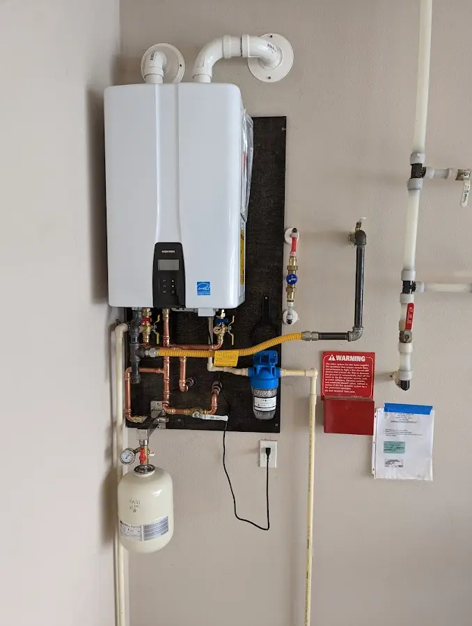 Professional plumber installing copper piping in a Pine Island home